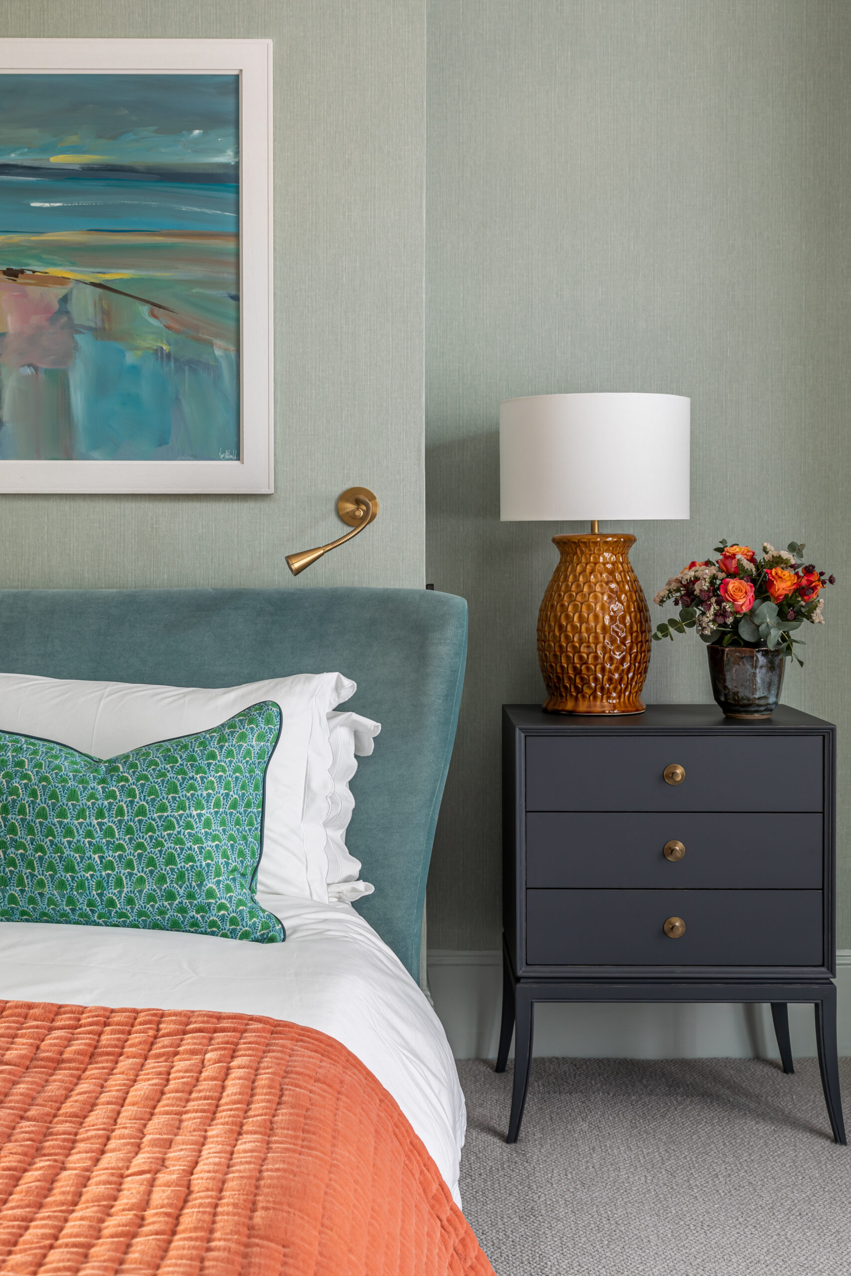 bedside table close up lamp green cushion