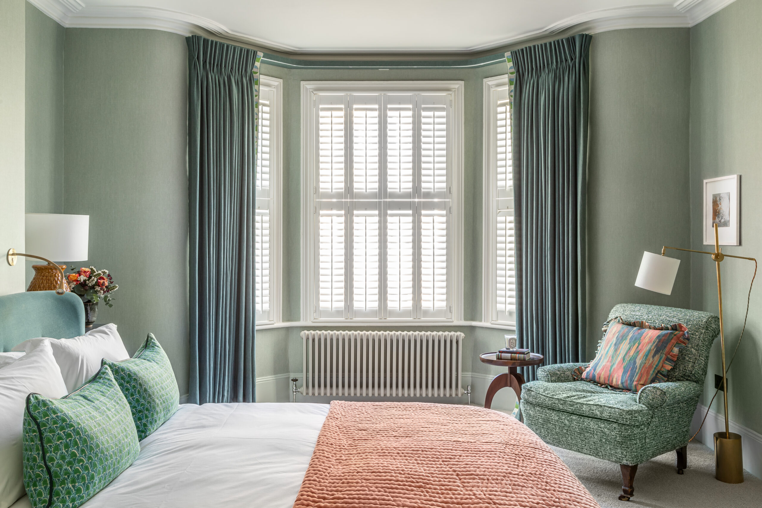 bedroom curtains, bed, armchair and wallpaper